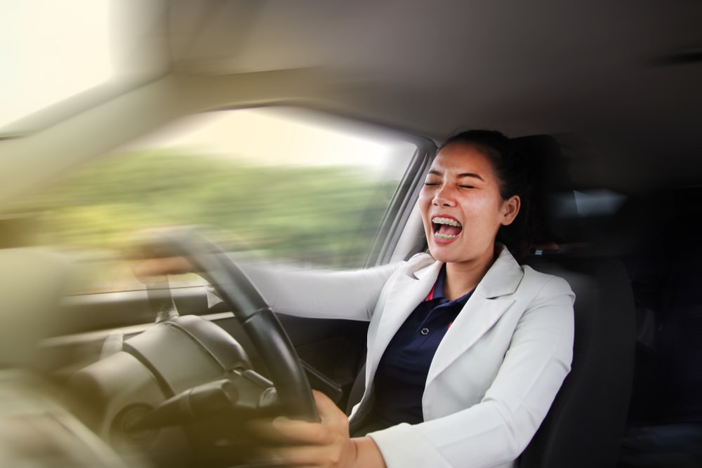 A Woman Speeding In A Car And Screaming