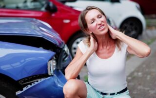 Woman Holding Her Neck In Pain After A Car Accident