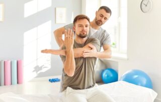 A patient and a doctor doing physical therapy.