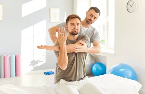 A patient and a doctor doing physical therapy